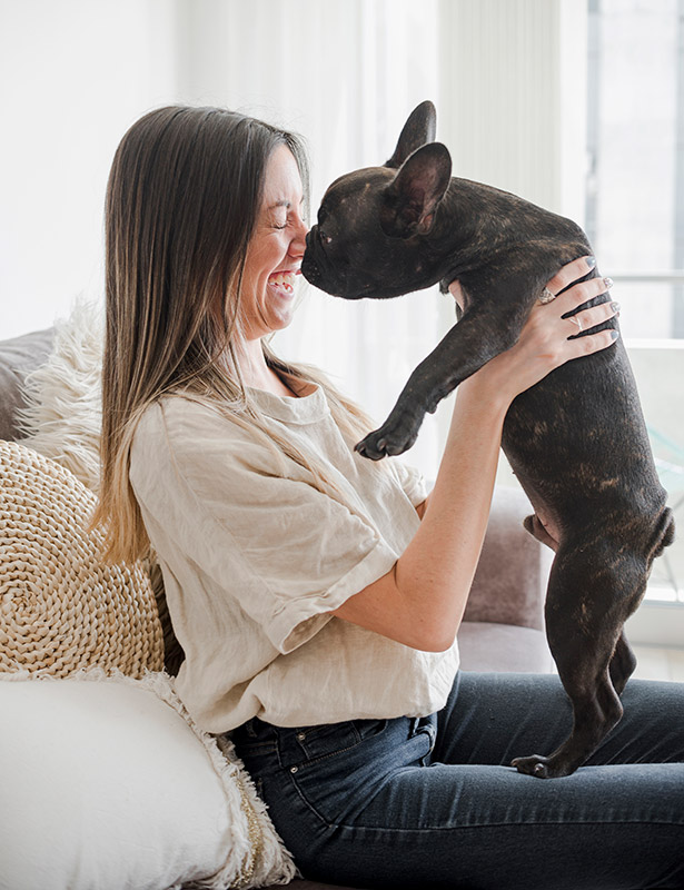 young-woman-playing-with-her-dog-615×800